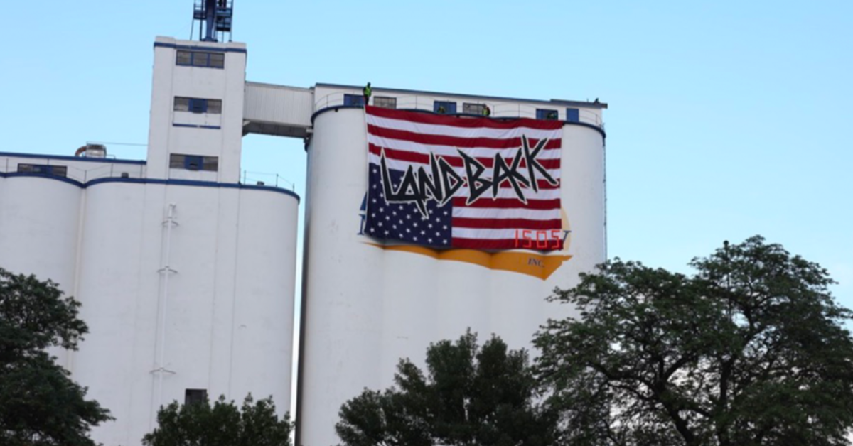 Four Arrested after NDN LANDBACK Campaign Mounts Upside-Down Flag From 100-Ft Grain Silo
